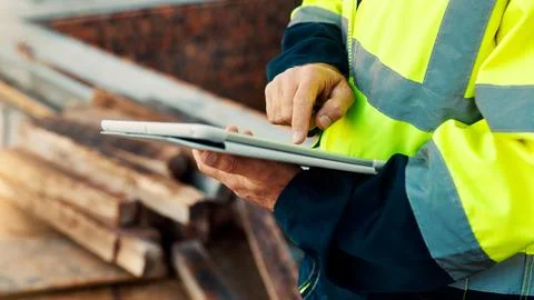 Person, hands and builder with tablet in construction site for building Stock Photos