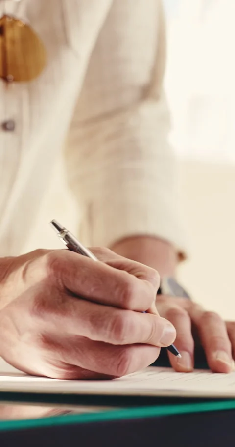 Person, hands and writing with document for registration, signing or checkin on Stock Footage 345653062