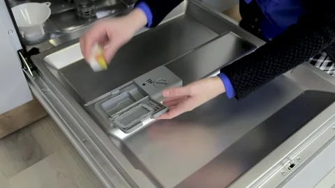 Person hands loads detergent "all in one" into the dishwasher Stock Footage 167797251
