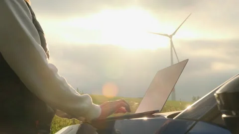 Person hands make notes of functioning wind turbine on field Stock Footage 202197447