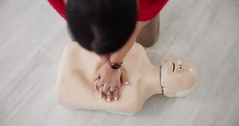 Person, hands or dummy with CPR above for first aid training or class at Stock Footage 297171245
