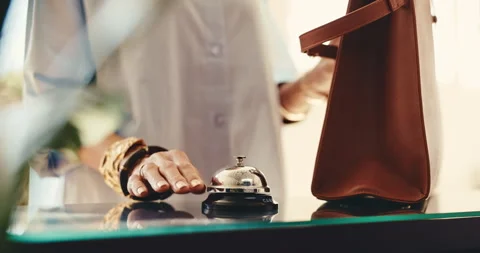 Person, hands or ringing with bell in reception desk for hotel accommodation or Stock Footage 345574809