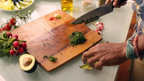 Person hands preparing dime herb on wooden chopping board - 25s Stock Footage 130033712