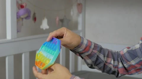Person hands presses bubbles on modern silicone toy pop it. Anti stress sensory  Stock Footage 159345400