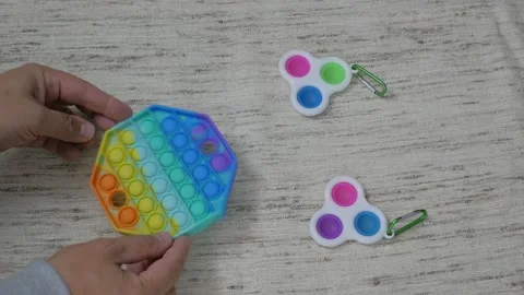 Person hands presses bubbles on modern silicone toy pop it. Anti stress sensory  Stock Footage 159345683