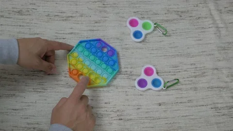 Person hands presses bubbles on modern silicone toy pop it. Anti stress sensory  Stock Footage 159345699