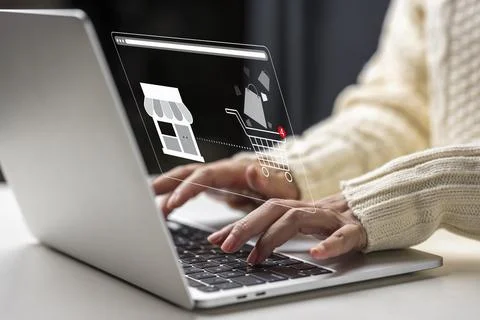 Person hands typing on laptop computer with virtual online store interface .. Stock Photos