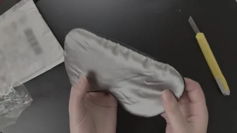Person hands unpack and demonstrate the parcel on black table. Vidéo 197801159