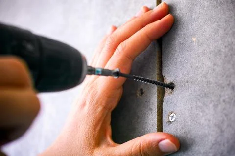 Person hands using screw drill. Stock Photos