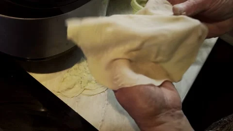 Person hands wrapping filling in thin dough sheets Stock Footage 337324882