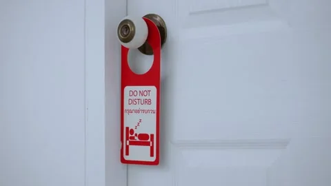 Person hangs card, do not disturb information on door handle in hotel room Stock Footage 244068944