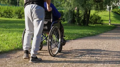 A person helping to disabled 動画素材 77877021