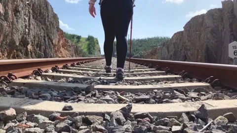 Person hiking along the railway track on the Alcolea bridge. Stock Footage