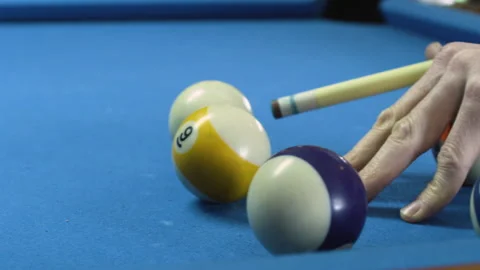 A person hits a pool ball on a pool table Stock Footage 132354586