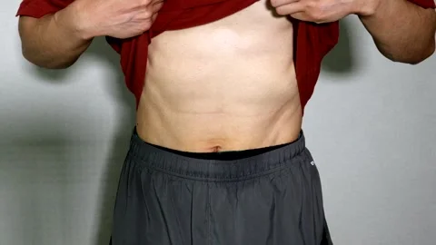 A person hitting their abs Stock Footage 334632558