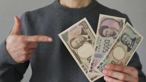 A person holding and pointing at three new banknotes Stock Footage 324544891