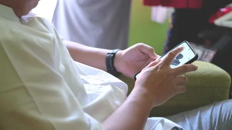 Person Holding and Using Smartphone. Scrolling social media app feed Stock Footage 201182561