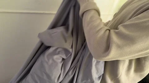 Person holding bed sheet preparing for change, home cleaning and laundry Stock Footage 337110727