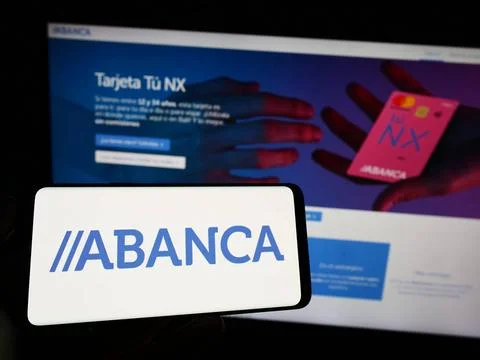  Person holding cellphone with logo of company ABANCA Corporacion Bancaria... Stock Photos