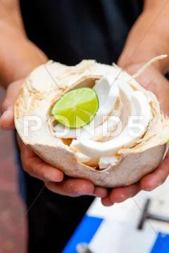 Person Holding Coconut With Lime