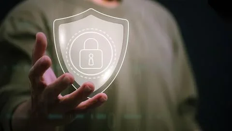Person holding digital shield with lock icon for security Stock Photos
