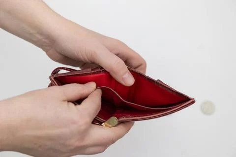Person Holding Empty Wallet With Single Coin on White Background Stock Photos