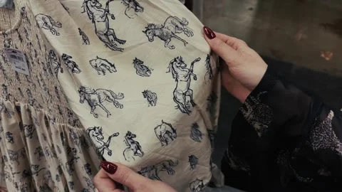 Person Holding Fabric with Horse Pattern Stock Footage 320109589