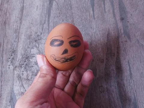 Person Holding Funny Easter Egg with Hand Drawn Face in Palm of Hand Stock Photos