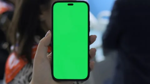 Person is holding a green iPhone Stock Footage 298943132