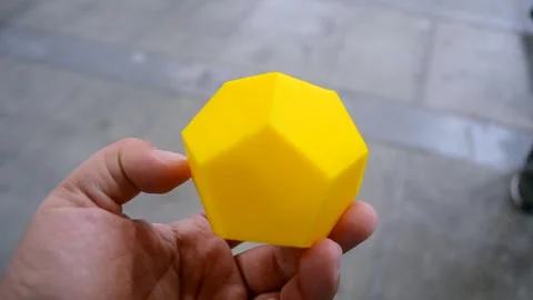 Person holding in hand object printed on a 3D printer. Geometric model printed Stock Footage 277918019