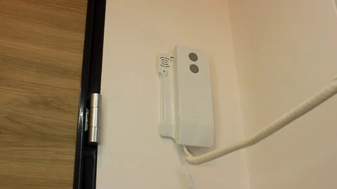 Person holding handset of intercom system Stock Footage 86414201