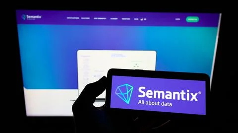 Person holding mobile phone with logo of company Semantix Tecnologia on screen Stock Photos