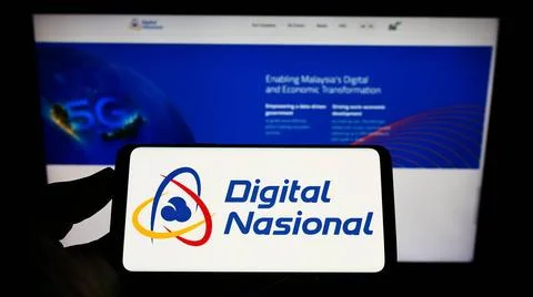 Person holding mobile phone with logo of Malaysian company Digital Nasiona... Stock Photos