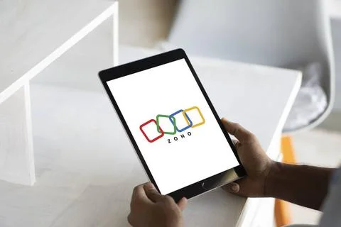  Person holding mobile phone with logo of Indian technology company Zoho C... Stock Photos