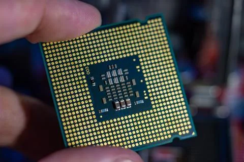 A person holding a modern computer processor component during hardware upgrade Stock Photos