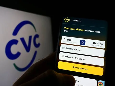 Person holding phone with webpage of company CVC Brasil Operadora e Agenci... Stock Photos