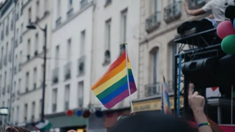 Person holding rainbow flag at pride parade Stock Footage 346990251