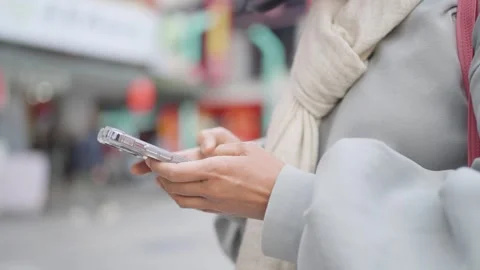 A person holding a remote control and a key, with business, technology, and comm Stock Footage 271236232