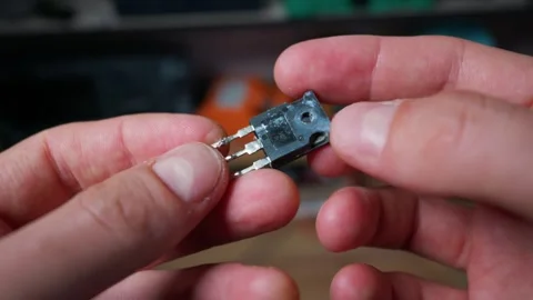 Person Holding Small Electronic Transistor Component Close Up in Workshop Stock Footage 339363724