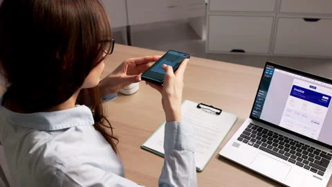 Person Holding A Smartphone Scanning A Document Stock Footage 335880114