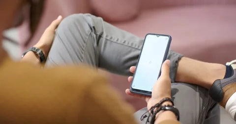 Person holding smartphone is waiting while app is loading after tapping screen Stock Footage 345071693