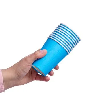 A person holding a stack of blue paper cups on isolated background. Stock Photos