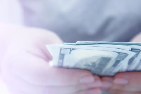 Person Holding Stack of Money Stock Photos