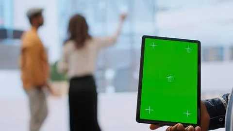 Person holding tablet with green interface Stock Photos