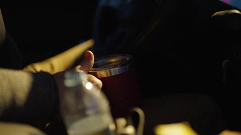 A Person Holding a Thermos Cup While Driving on a Hunting Road Trip - POV Shot Stock Footage 336303595
