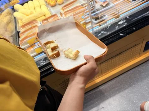 Person Holding Tray with Bread Samples in a Bakery Stock Photos