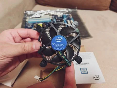 A person holds a computer processor cooler. Aluminum heat sink fan 写真素材