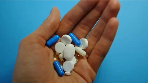 https://images.pond5.com/person-holds-many-pills-hand-footage-129320516_iconl.jpeg