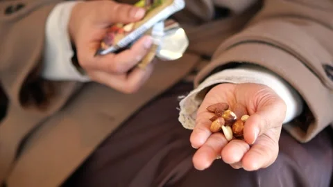 Person holds mixed nuts and snacks in their hand Stock Footage 333298620