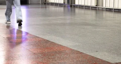 A person hurrying through the concourse of an empty train station Vídeos de archivo 346640576